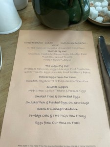 A large-print breakfast menu printed on A4 paper Breakfasts included both vegetarian and standard full breakfasts, smoked kippers and Eggs Benedict.