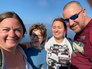 Family selfie on the deck of the ferry. Left to right are Kath, William, Kira and Chris